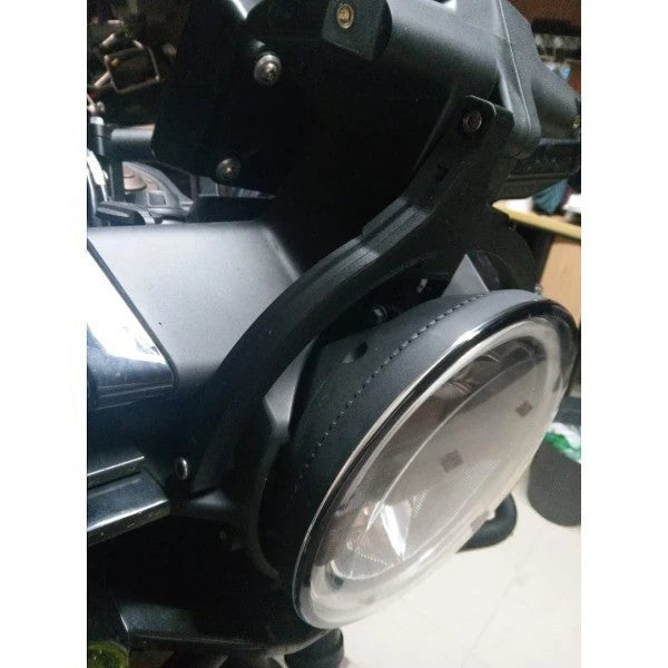 Moto Explorer black ASA Prime navigation stabiliser mounted on a Husqvarna Norden 901 motorcycle headlight assembly.